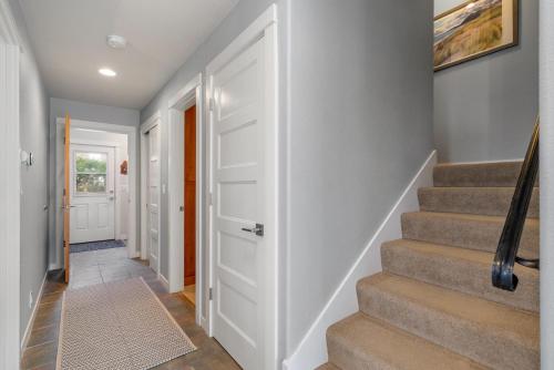 a hallway with stairs and a white door at The Cachalot MCA#4046 in Manzanita