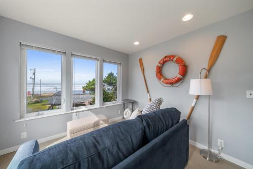 a living room with a blue couch and a window at The Cachalot MCA#4046 in Manzanita