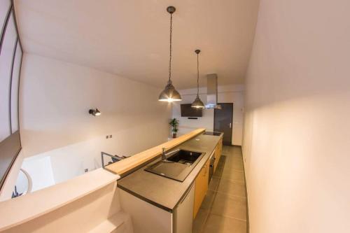 a kitchen with a sink and a counter top at Joli loft atypique - Métro Valmy in Lyon