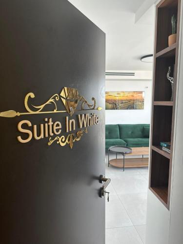 a door with a sign that reads suite in white at Suite In White in ‘Akko