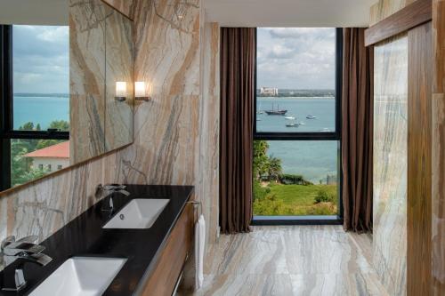 a bathroom with two sinks and a large window at Element by Westin Hotel Dar es Salaam in Dar es Salaam