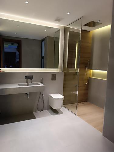 a bathroom with a toilet and a sink and a shower at Valley CLIFF INN in Al Jināh