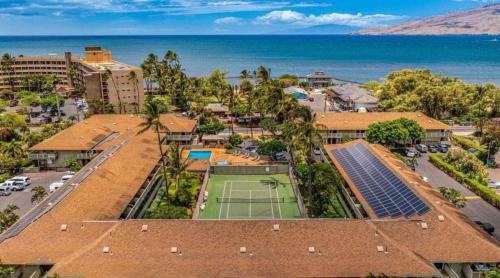 an aerial view of a tennis court and buildings and the ocean at 3mins Walk to Beach! Laundry, Pool, Hot Tub & More in Kihei