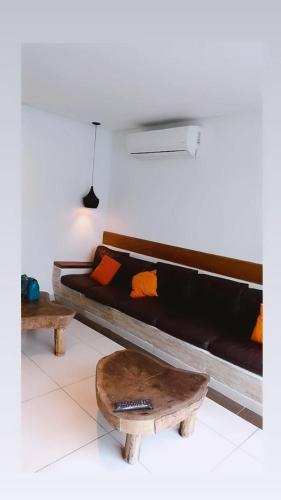 a living room with a couch and a coffee table at Pippo Suites Guarujá in Guarujá