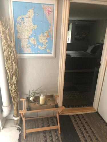 a mirror in a room with a map on the wall at Guesthouse Trabjerg in Vejle