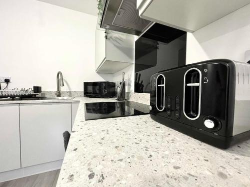 a kitchen with a black appliance on a counter at 1 Silvester Square in Hull