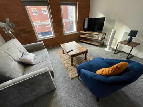 a living room with a couch and a tv at 1 Silvester Square in Hull