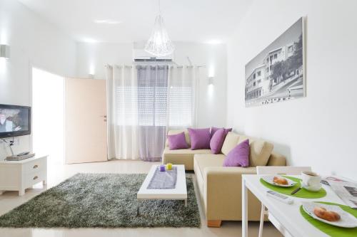 a living room with a couch and a table at Eshkol Housing Haifa -Executive Apartments in Haifa