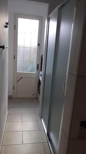 a hallway of a bathroom with a door and a window at Orgosio in Santa Maria Navarrese