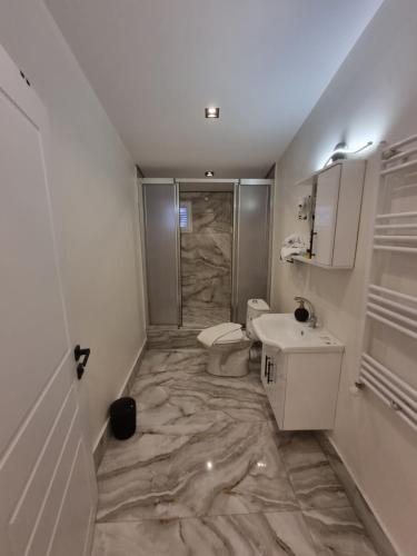 a bathroom with a sink and a toilet and a shower at Elite Park Hotel & Suites in Beylikduzu