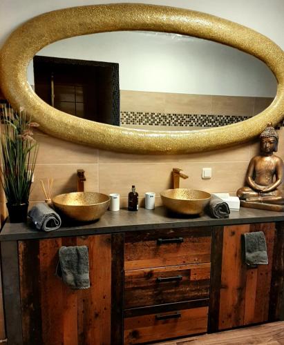 a bathroom with two sinks and a large mirror at Haus Waldblick in Liebenwalde