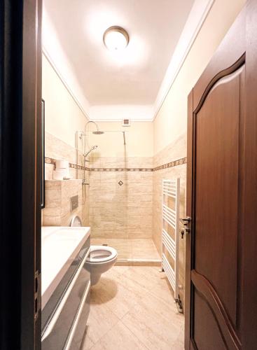 a bathroom with a toilet and a shower at Excelsior INN in Turda