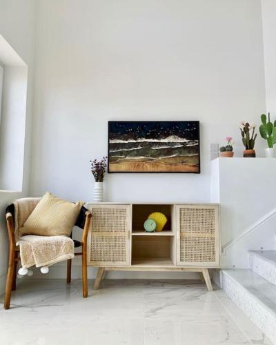 a living room with a chair and a table at Luxury Beachfront Home in Gibraltar