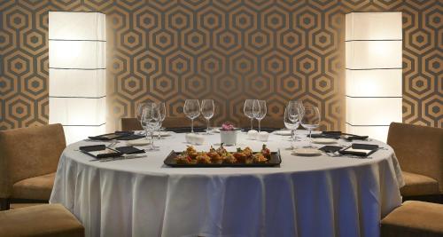 a table with wine glasses and a tray of food on it at Abba Euskalduna Hotel in Bilbao