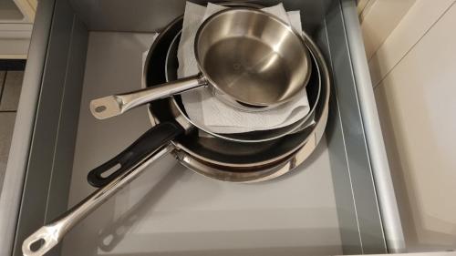 a metal pot in a drawer in a kitchen at Route du Village 5 Residence Panorama in Villars-sur-Ollon