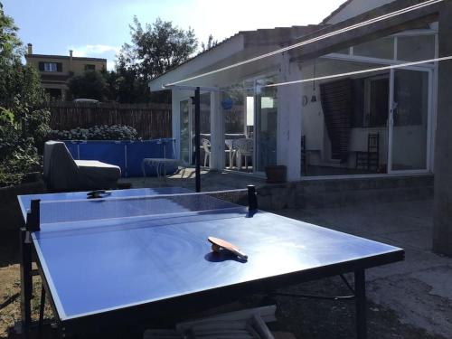 a ping pong table in front of a house at Numancia 12 in Santa María de la Alameda