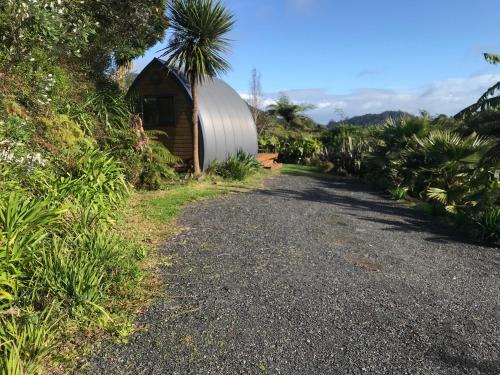 a road leading to a silo and a building at The Dome Waikino in Waikino