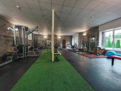 a gym with a green carpet in the middle at Cozy room with kitchen near the lake in Tõrva