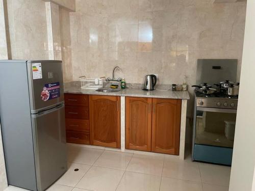 eine Küche mit einem Kühlschrank aus Edelstahl und einem Herd in der Unterkunft Hermoso minidepartamento in Huaraz