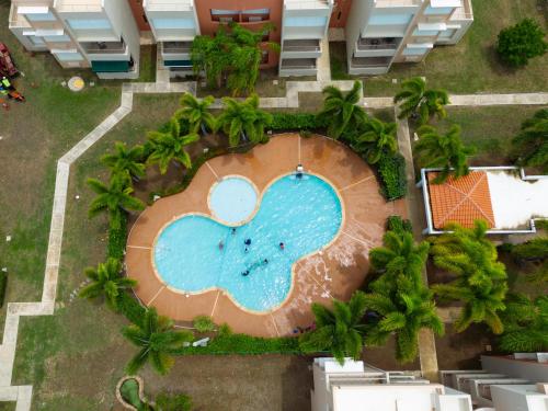 an overhead view of a swimming pool at a resort at Coqui Beach Home, Paseo del Faro Combate in Cabo Rojo