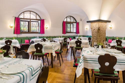 a dining room with white tables and chairs at Hotel Goldener Hirsch, A Luxury Collection Hotel, Salzburg in Salzburg
