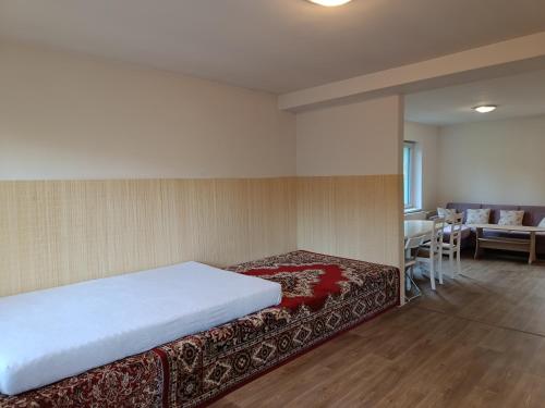 a bedroom with a bed and a table and chairs at Chalupa u Martina in Vápenice