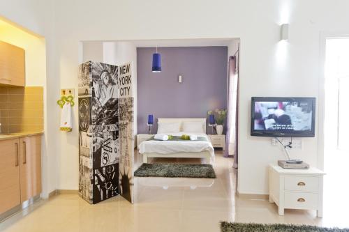 a bedroom with a bed and a tv in it at Eshkol Housing Haifa -Executive Apartments in Haifa