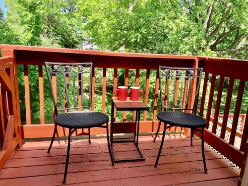 two chairs and a table on a deck at Convenient 2BR/3BD pet friendly Apartment with private entrance in Chicopee