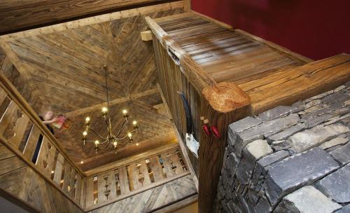 an overhead view of a wooden building with a chandelier at Black Diamond Sainte Foy Chalets in Sainte-Foy-Tarentaise