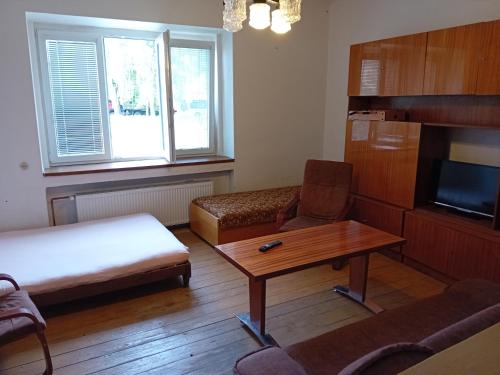 a room with a bed and a table and a couch at Statek in Veverská Bítýška