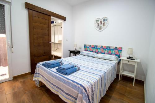 モトリルにあるRentitSpain Carrera del Mar, 17 Apartamentoのベッドルーム1室(青い枕2つ付)