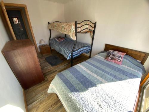 a bedroom with two bunk beds and a mirror at Hostal LV in Los Vilos