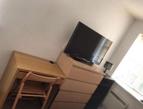 a desk with a flat screen tv on top of it at The Right Place. A Fabulous/Cozy Double Room in London