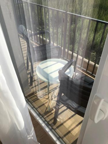 a balcony with two chairs and a table at ADAMZ in Vama Veche