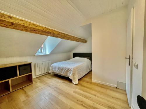 a bedroom with a bed in a attic at La Maison de Jade in Gex