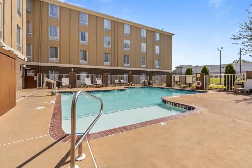 a swimming pool in front of a building at Holiday Inn Express Hotel & Suites Starkville, an IHG Hotel in Starkville