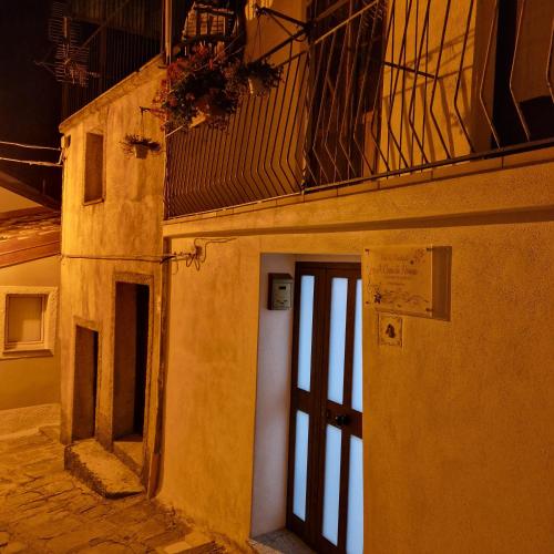 a building with a door and a balcony on top of it at A Casa di Nonna in Castelsaraceno