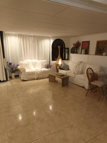 uma sala de estar com sofás brancos e uma mesa em Patalavaca, aguamarina em Patalavaca