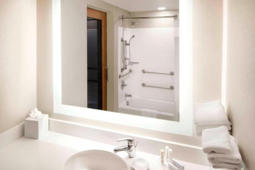 a bathroom with a sink and a mirror at SpringHill Suites Indianapolis Downtown in Indianapolis