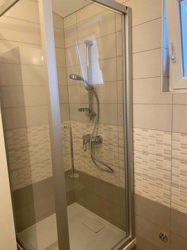 a shower with a glass door in a bathroom at Apartment Klara in Krk