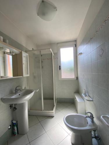 a bathroom with a shower and a sink and a toilet at ATLAS in Serravalle Sesia