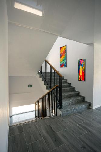 a staircase in a house with two paintings on the wall at ADAMZ in Vama Veche