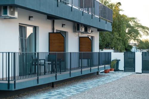 a building with wooden doors and a fence at ADAMZ in Vama Veche