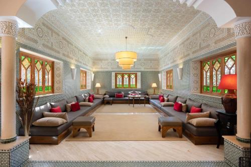 a large living room with couches and a ceiling at Domaine Abiad in Marrakech