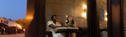 a man and a woman sitting at a table at The Thomas Hotel - Premium Suite Main Level in Tyler
