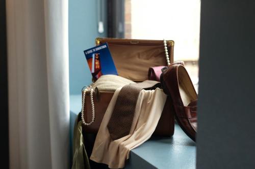 a pile of bags sitting on top of a table at The Thomas Hotel - Premium Suite Main Level in Tyler