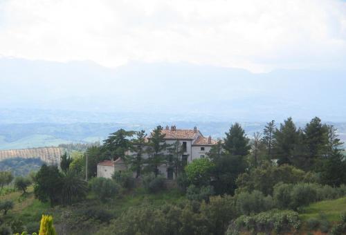 a house on top of a hill with trees at Agriturismo Miracco Atanasio Franco "Il Maniero" in Santa Sofia dʼEpiro