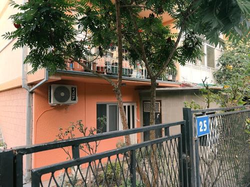 a orange house with a fence in front of it at Sanska 25 in Dušanovac (historical)
