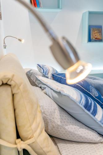 a pile of pillows sitting on a bed with a stethoscope at Theoxenia Kasos Luxury Apartments in Panayía