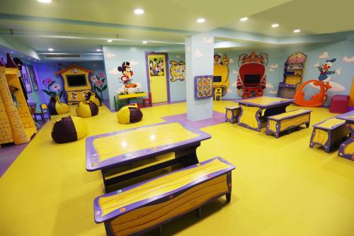 a childrens play room with slides and other toys at Astral Palma Hotel in Eilat